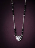 Necklace with heart-shaped diamond pendant on a dark background