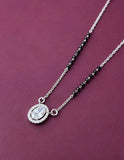 Silver necklace with a pendant on a purple background
