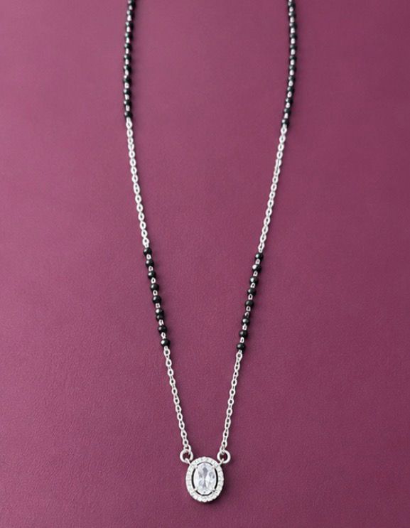 Silver necklace with a pendant on a purple background