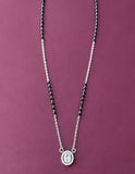 Silver necklace with a pendant on a purple background