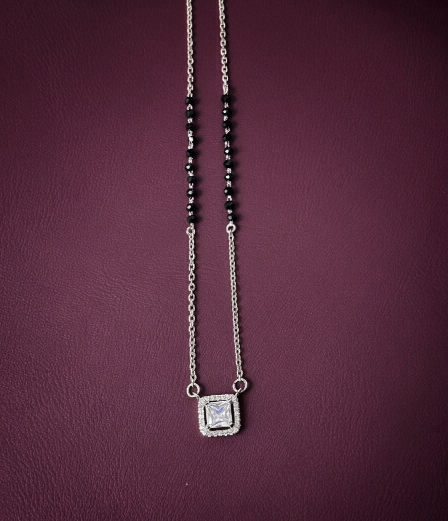 Necklace with a square pendant on a purple background