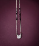 Necklace with a square pendant on a purple background