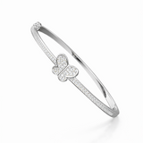 Silver bracelet with butterfly charm on a white background