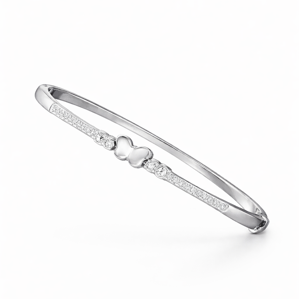 Silver bracelet with a heart charm on a white background