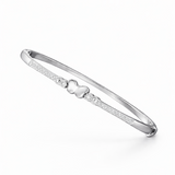 Silver bracelet with a heart charm on a white background