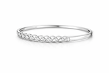 Silver bracelet with intricate design on a white background