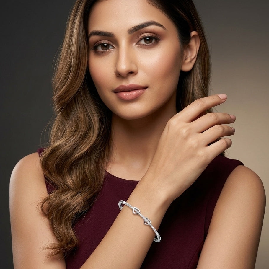 Woman wearing a silver bracelet on a dark background
