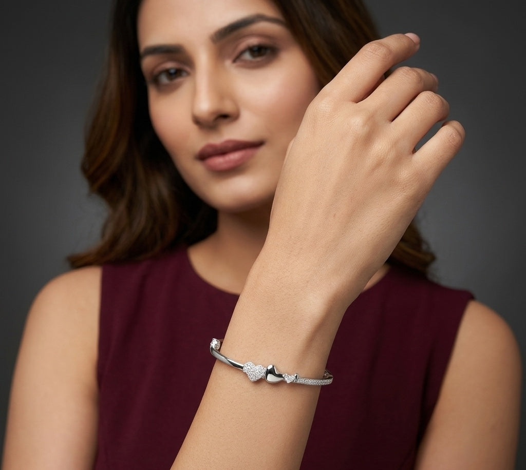 Woman wearing a silver bracelet on a dark background