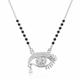 Silver eye-shaped pendant necklace with black beads on a white background