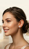 Woman wearing diamond earrings with a blurred background