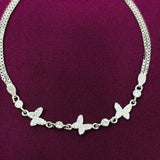 Silver butterfly bracelet on a purple fabric background