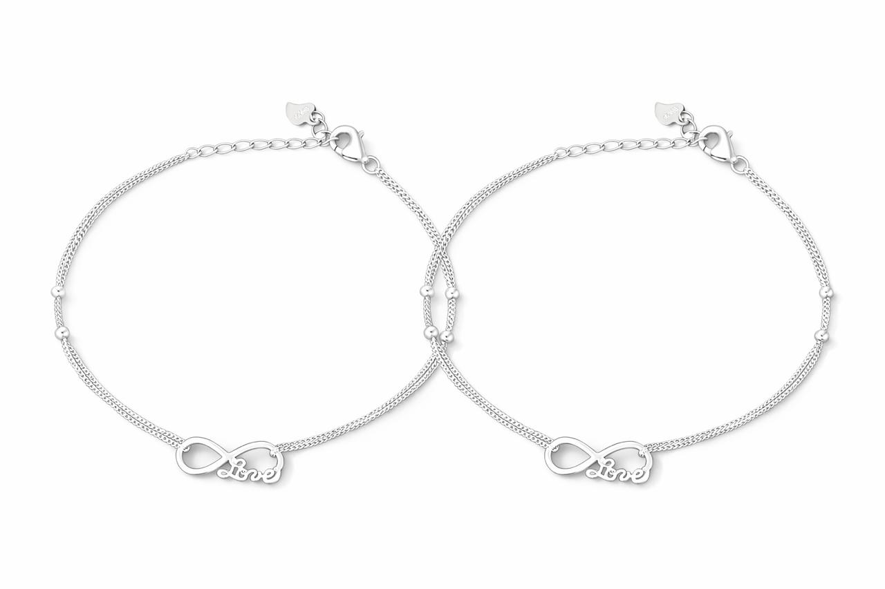 Two silver anklets with infinity symbols on a white background