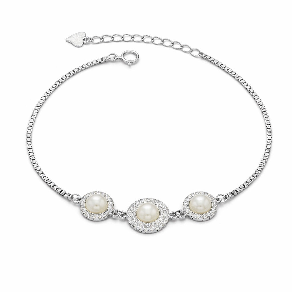 Silver bracelet with three pearls on a white background