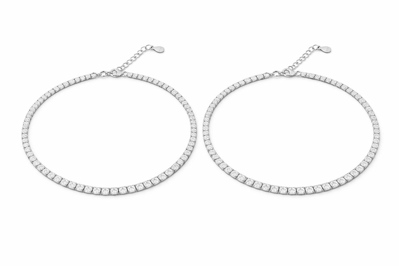 Two silver tennis payal on a white background
