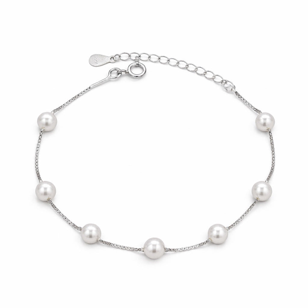 Silver bracelet with pearls on a white background