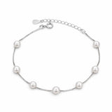 Silver bracelet with pearls on a white background