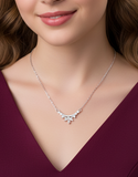 Necklace with a floral pendant worn by a model against a plain background
