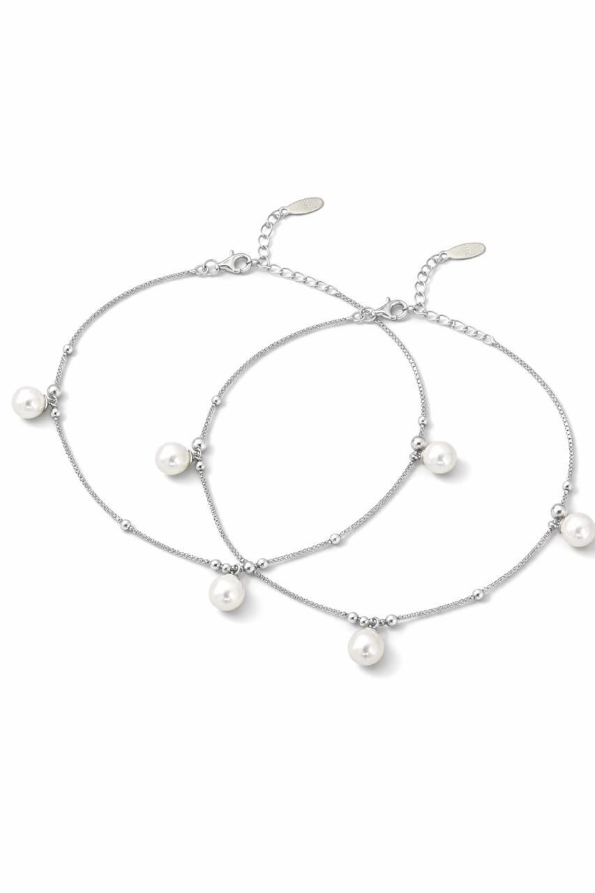 Two pearl anklets on a white background