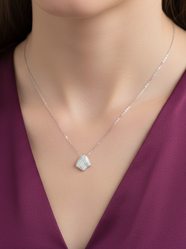 Necklace with a diamond pendant on a model wearing a purple top