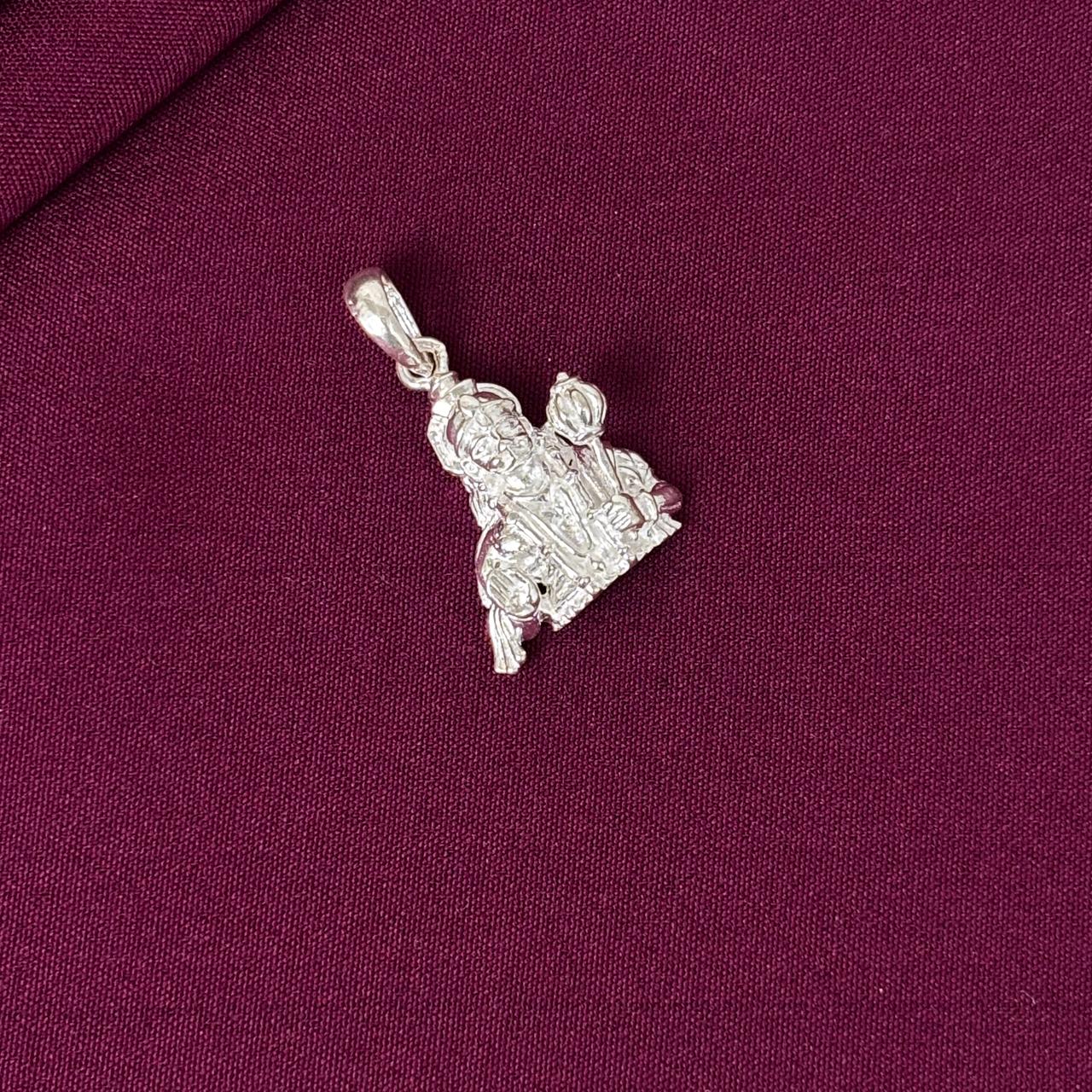 Silver pendant on a purple fabric background