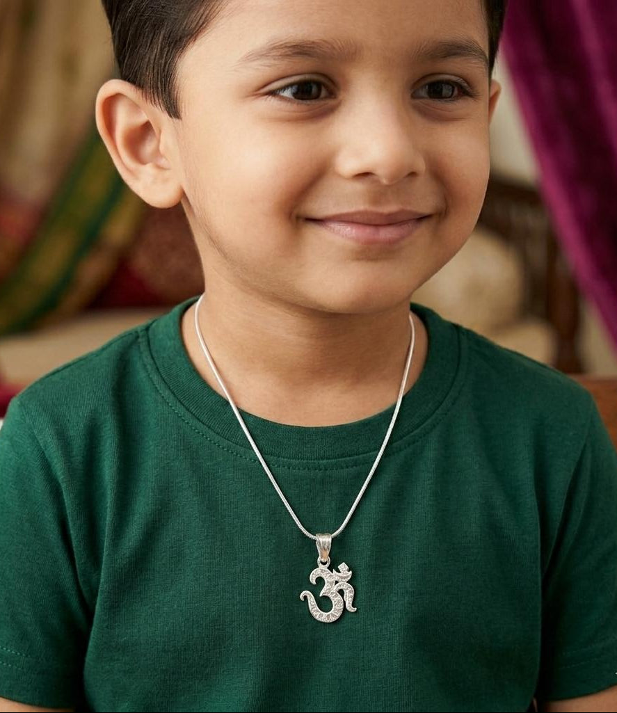 Child wearing a green shirt and silver necklace with a pendant
