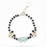 Silver Bracelet with black beads, cartoon character charms, and a butterfly charm on a white background