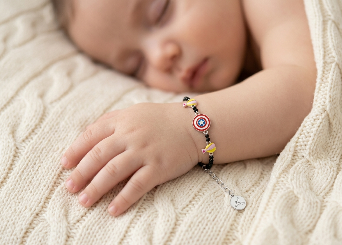 Child's hand wearing a silver bracelet with a heart charm on a textured surface