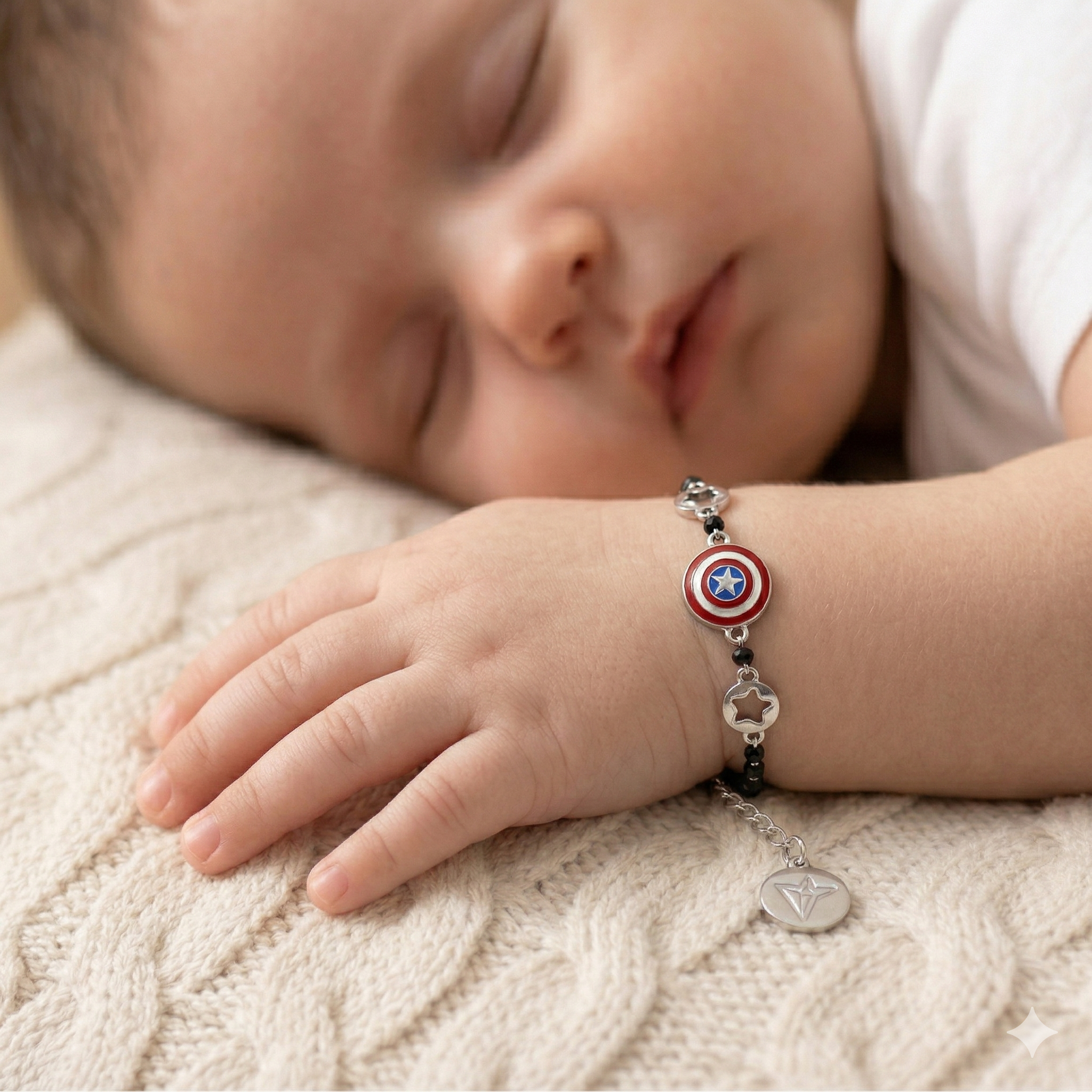 Child's hand wearing a silver bracelet with superhero design on a soft surface