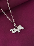 Silver elephant pendant on a chain against a purple fabric background