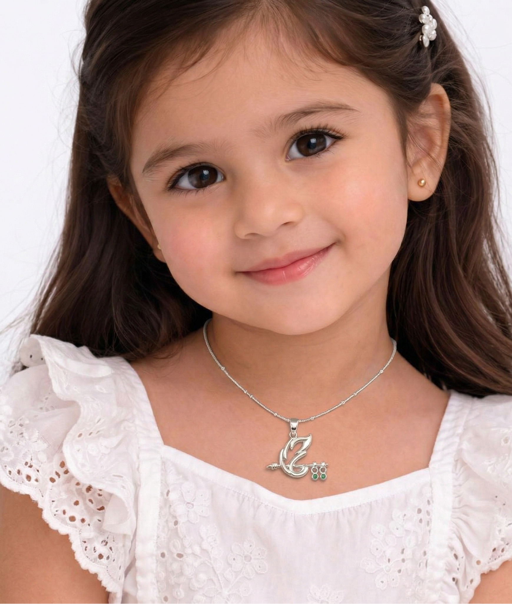 Young girl wearing a white dress with a necklace on a white background