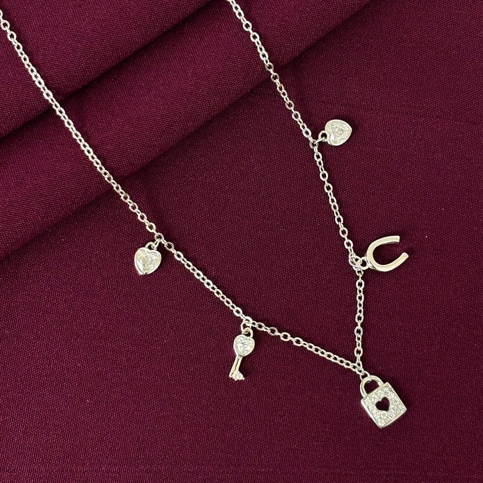 Necklace with heart-shaped padlock charm on a burgundy fabric background