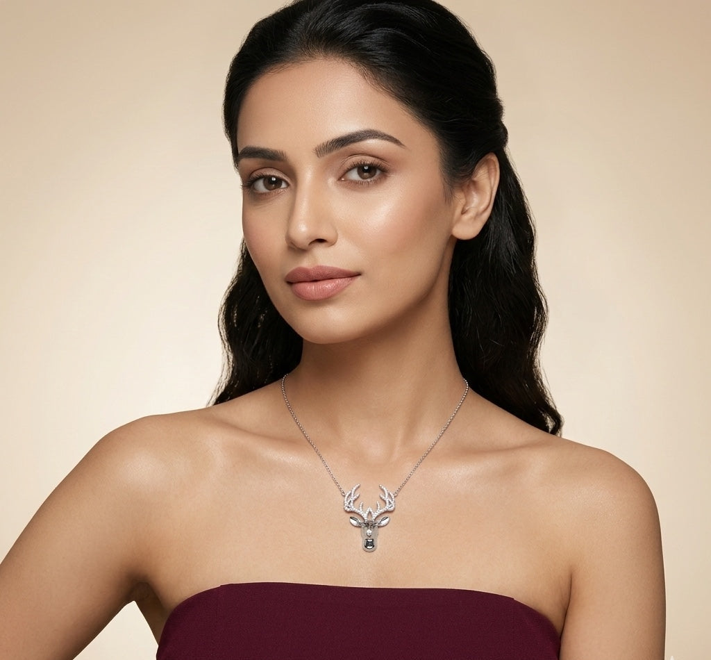 Woman wearing a silver necklace with a deer pendant against a beige background