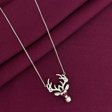 Necklace with a deer head pendant on a burgundy fabric background