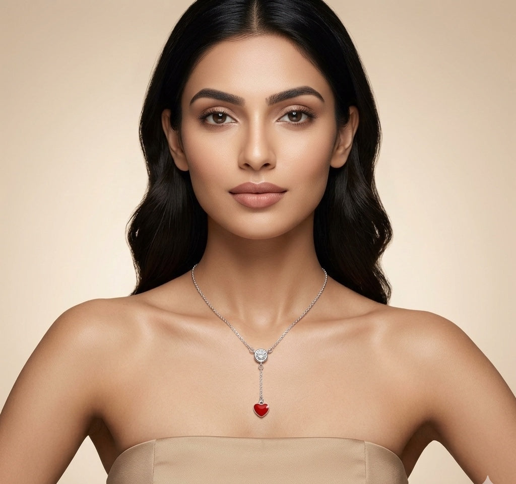 Woman wearing a necklace with a red heart pendant on a beige background