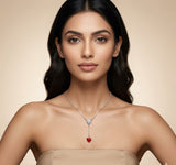 Woman wearing a necklace with a red heart pendant on a beige background