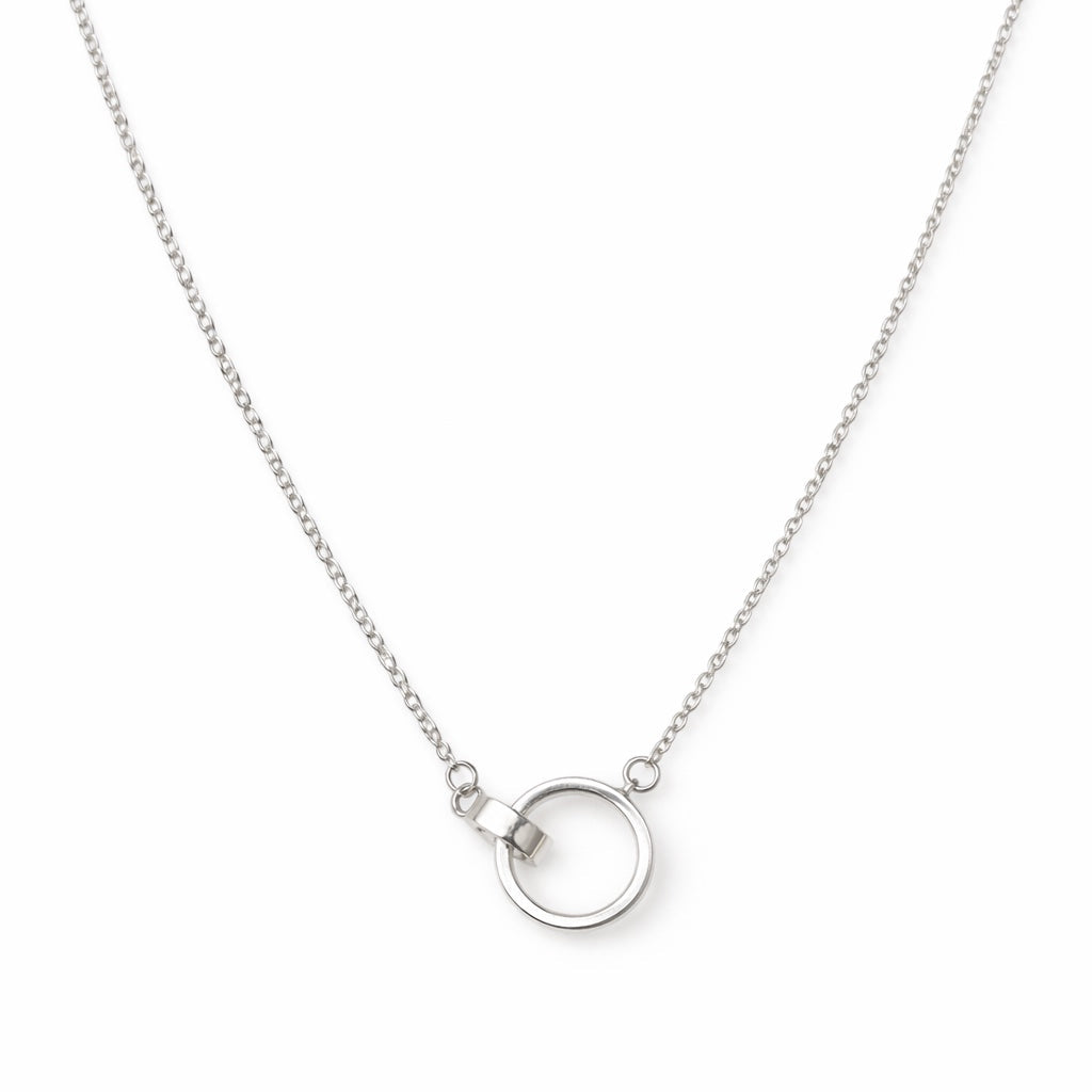 Silver necklace with a small circular pendant on a white background