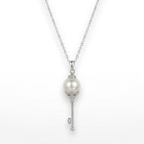 Pearl key pendant necklace on a white background