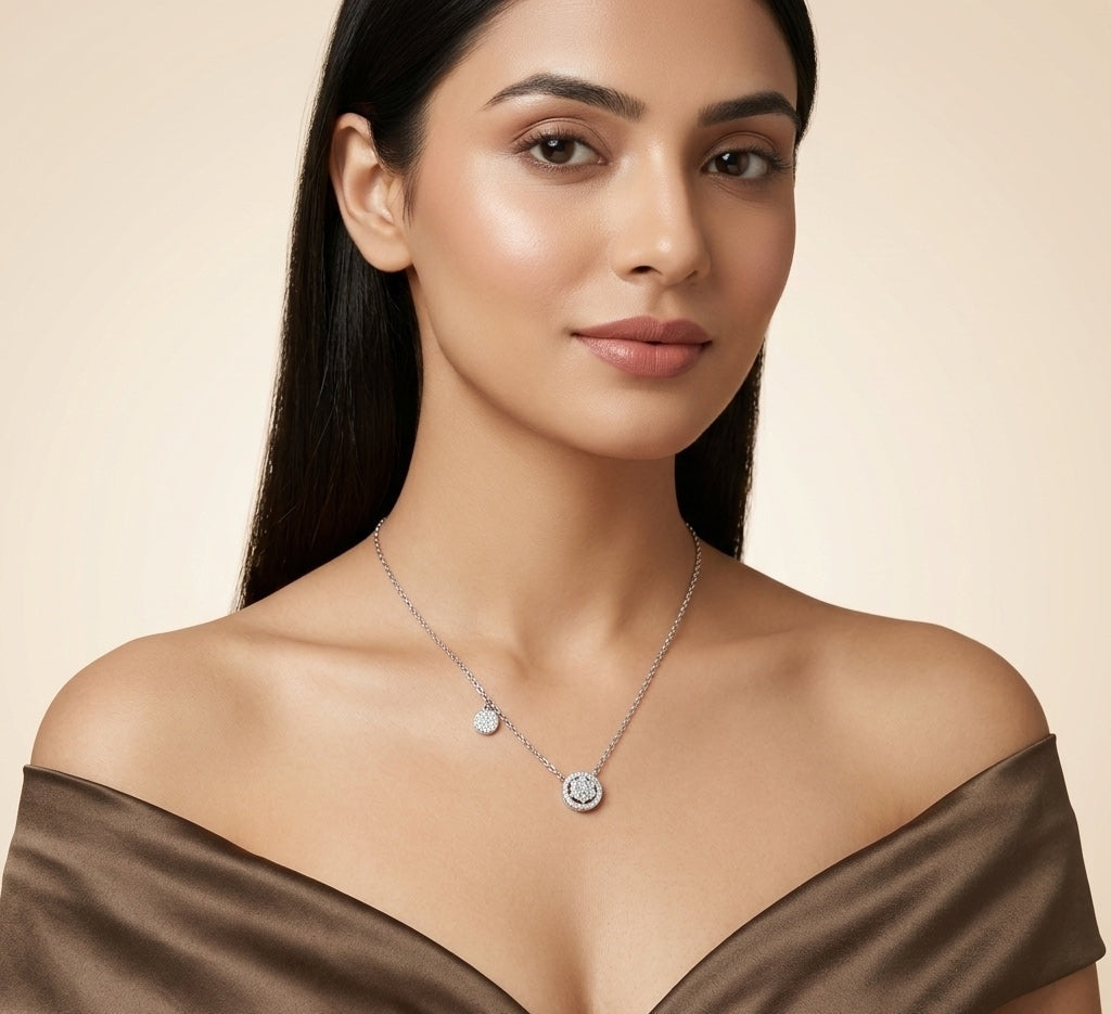 Woman wearing a silver necklace with a beige background