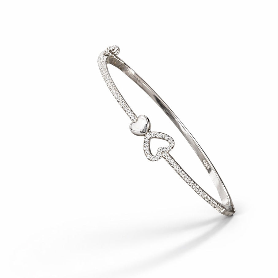 Silver bracelet with heart design on a white background