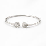 Silver bracelet with floral charm on a white background