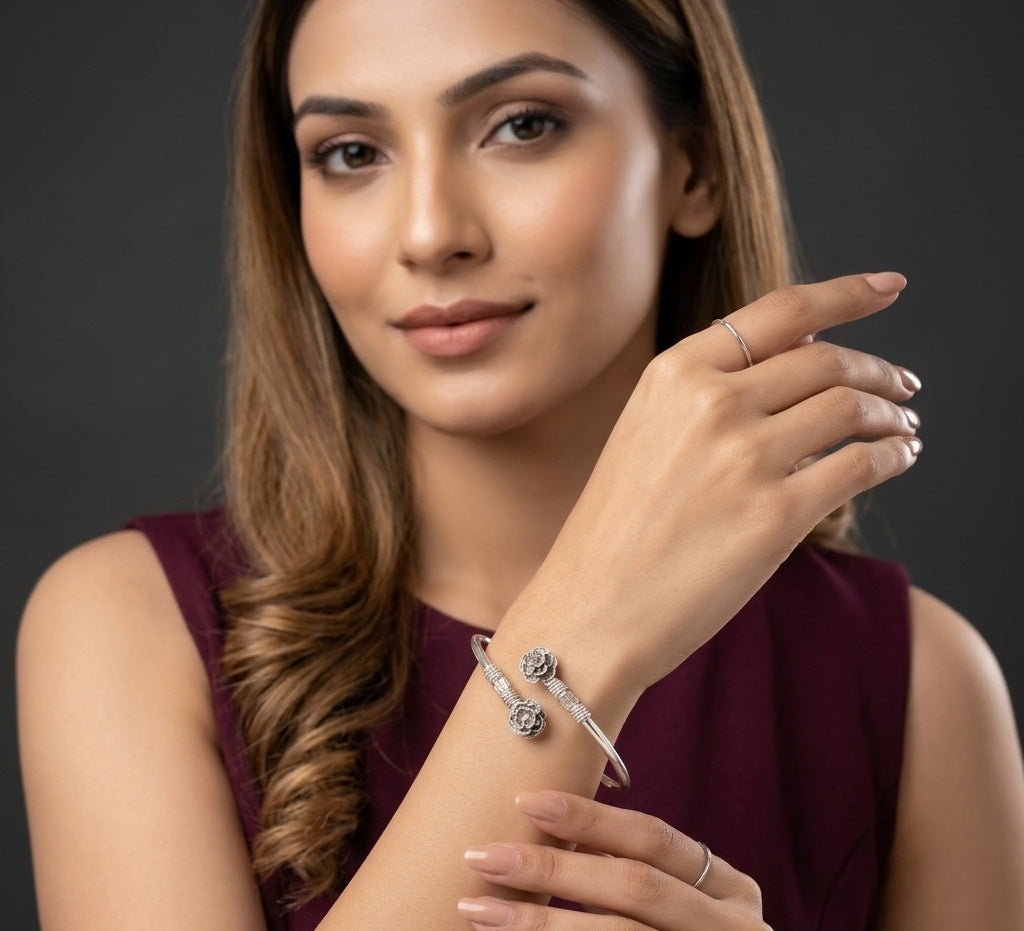 Woman wearing a bracelet and ring, with a dark background