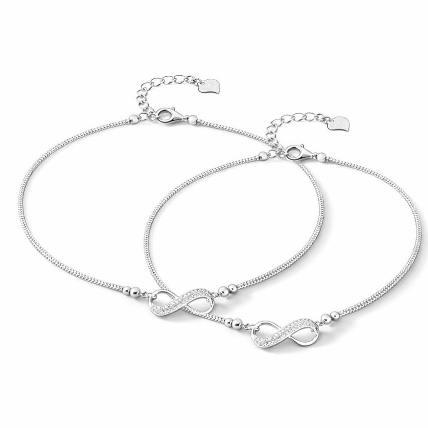 Two silver anklet with infinity symbols on a white background