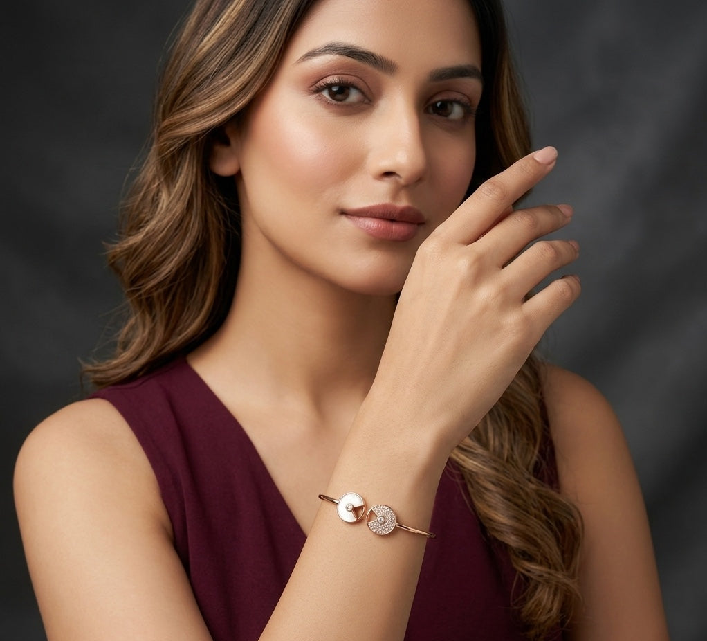 Woman wearing a gold bracelet on a dark background