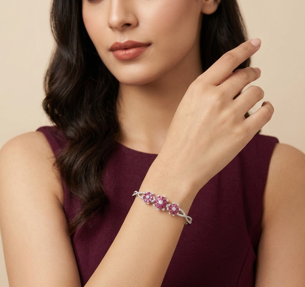 Woman wearing a bracelet with pink gemstones on a beige background
