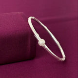 Silver bracelet on a purple fabric background