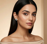Woman wearing a blue gemstone earring against a beige background