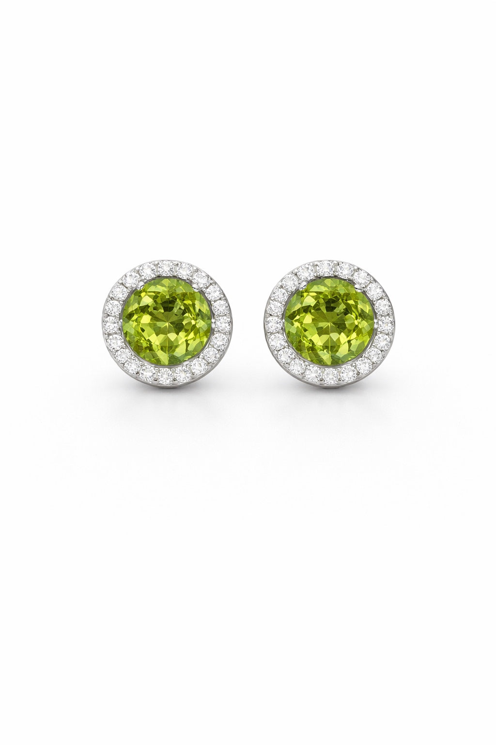 Pair of round green gemstone earrings with silver borders on a white background