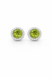 Pair of round green gemstone earrings with silver borders on a white background