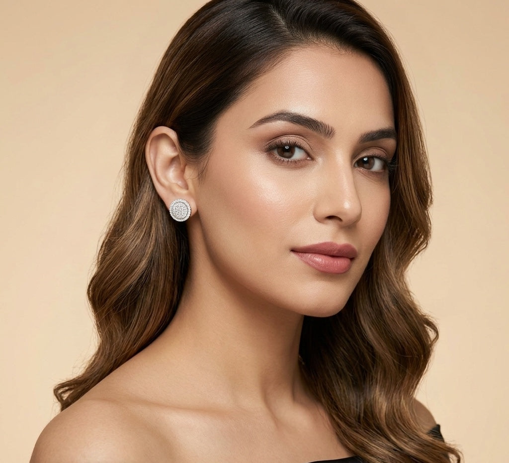 Woman wearing diamond earrings against a beige background