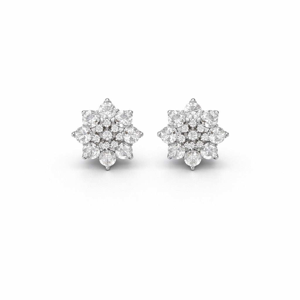 Pair of diamond flower earrings on a white background